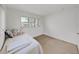 Cozy bedroom with a sunlit window and neutral carpeting creating a serene atmosphere at 3515 100Th N Ter, Pinellas Park, FL 33782