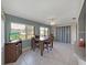 Bright dining area with tile floors, a ceiling fan, and backyard views through large windows at 3515 100Th N Ter, Pinellas Park, FL 33782