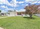 Charming single-story home with a well-manicured lawn and colorful red shutters at 3515 100Th N Ter, Pinellas Park, FL 33782
