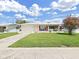 Charming single-story home with a well-manicured lawn and colorful red shutters at 3515 100Th N Ter, Pinellas Park, FL 33782