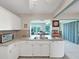 Bright and functional kitchen with white cabinets, stainless steel sink, and modern appliances at 3515 100Th N Ter, Pinellas Park, FL 33782