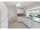 Bright kitchen features white cabinets, appliances, tile flooring, and eat-in dining area at 3515 100Th N Ter, Pinellas Park, FL 33782