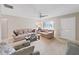Bright living room featuring neutral walls, cozy sofas, and a glass-top coffee table at 3515 100Th N Ter, Pinellas Park, FL 33782