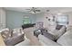 Open-concept living area with a sofa, love seat, and view into the kitchen and dining area at 3515 100Th N Ter, Pinellas Park, FL 33782