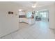 Open living space featuring white cabinets, tile floors, and natural light, perfect for entertaining at 3515 100Th N Ter, Pinellas Park, FL 33782