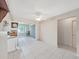 Bright living space featuring white cabinets, tile floors, and natural light, creating an airy ambiance at 3515 100Th N Ter, Pinellas Park, FL 33782