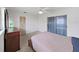 Spacious main bedroom features wood furniture and sliding glass door to the outside at 3515 100Th N Ter, Pinellas Park, FL 33782