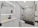 Contemporary bathroom featuring marble tiled shower and modern black fixtures at 3614 Vasco St, Punta Gorda, FL 33950