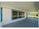 Wide front porch with blue trim provides ample space for outdoor seating at 3614 Vasco St, Punta Gorda, FL 33950