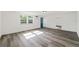 Bright living room with hardwood floors, white walls, and natural light from windows at 3614 Vasco St, Punta Gorda, FL 33950