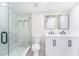 Modern bathroom featuring a glass-enclosed shower, and double sink vanity at 3617 E Louisiana Ave, Tampa, FL 33610