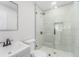Updated bathroom featuring a glass shower, gray vanity, and modern fixtures at 3617 E Louisiana Ave, Tampa, FL 33610