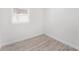 Minimalist bedroom with wood-look floors and a window at 3617 E Louisiana Ave, Tampa, FL 33610