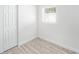 Bright bedroom features neutral walls, wood-look floors, and a window for natural light at 3617 E Louisiana Ave, Tampa, FL 33610