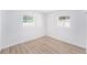 A bright bedroom with two windows and light-colored, wood-look flooring at 3617 E Louisiana Ave, Tampa, FL 33610