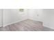 Light-filled room with wood-look floors and fresh white walls at 3617 E Louisiana Ave, Tampa, FL 33610