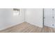 Cozy bedroom featuring light wood-look flooring, window and closet at 3617 E Louisiana Ave, Tampa, FL 33610