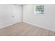 Clean and bright bedroom with wood-look flooring and a window at 3617 E Louisiana Ave, Tampa, FL 33610