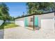 Charming exterior features turquoise doors, a gravel yard, and a modern design at 3617 E Louisiana Ave, Tampa, FL 33610