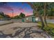Cozy home with fresh exterior paint, gravel driveway, and landscaping creating an inviting curb appeal at 3617 E Louisiana Ave, Tampa, FL 33610
