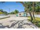 Beautiful white home with a vibrant teal door and modern white gravel landscaping at 3617 E Louisiana Ave, Tampa, FL 33610