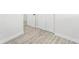 Hallway featuring wood-look flooring, base molding, and a set of doors at 3617 E Louisiana Ave, Tampa, FL 33610