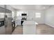 New kitchen with stainless steel appliances, center island, and white cabinets at 3617 E Louisiana Ave, Tampa, FL 33610