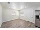 A bright empty room featuring wood-look floors and fresh white walls at 3617 E Louisiana Ave, Tampa, FL 33610