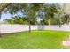 Large backyard with a lush lawn, shade trees, and a privacy fence for outdoor enjoyment at 3814 W Sevilla St, Tampa, FL 33629