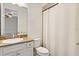 Bathroom featuring granite countertop, white vanity, and shower with curtain at 3814 W Sevilla St, Tampa, FL 33629