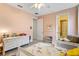 Bright pink bedroom with bed and view into bathroom at 3814 W Sevilla St, Tampa, FL 33629