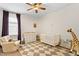 Neutral Bedroom with crib, changing table, chair, and diamond pattern rug at 3814 W Sevilla St, Tampa, FL 33629