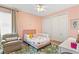 Bright pink bedroom with twin bed, curtains, and chair at 3814 W Sevilla St, Tampa, FL 33629