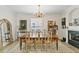Dining room featuring a wooden table, neutral chairs, chandelier and fireplace at 3814 W Sevilla St, Tampa, FL 33629