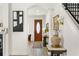 Bright foyer featuring hardwood floors, elegant decor, artwork, and a staircase at 3814 W Sevilla St, Tampa, FL 33629
