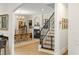 Hallway connecting dining room and stairs featuring a fireplace, chandelier, and decorative wall sconces at 3814 W Sevilla St, Tampa, FL 33629