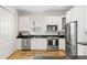 Bright kitchen with stainless appliances, white cabinets, and granite countertops at 3814 W Sevilla St, Tampa, FL 33629