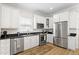 Bright kitchen with stainless steel appliances, white cabinetry, and granite countertops at 3814 W Sevilla St, Tampa, FL 33629