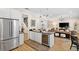 Open-concept kitchen featuring a wine cooler, granite counters, and seamless flow to living area at 3814 W Sevilla St, Tampa, FL 33629