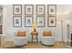 Cozy sitting area featuring two comfortable chairs, a table, and wall art, creating a warm and inviting space at 3814 W Sevilla St, Tampa, FL 33629