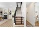 Staircase with sleek black railings and wood treads, enhancing the modern design of the home at 3814 W Sevilla St, Tampa, FL 33629
