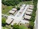 Aerial perspective of the property, highlighting multiple buildings, lush landscaping, and ample parking space at 4015 My Lady Ln # 7, Land O Lakes, FL 34638