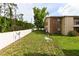 Spacious backyard featuring lush green grass, trees, and a white fence for privacy and security at 4015 My Lady Ln # 7, Land O Lakes, FL 34638