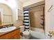 This bathroom features a shower-tub combo, tiled walls, a stylish vanity, and functional storage at 4015 My Lady Ln # 7, Land O Lakes, FL 34638
