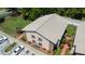 The building exhibits a tan facade with brick accents, complementing its shingled roof in this aerial view at 4015 My Lady Ln # 7, Land O Lakes, FL 34638