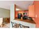 Kitchen with bar stool seating, wood cabinets, black appliances, and an adjacent dining area at 4015 My Lady Ln # 7, Land O Lakes, FL 34638