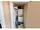 Convenient laundry area featuring a stacked washer and dryer, along with storage shelving for supplies at 4015 My Lady Ln # 7, Land O Lakes, FL 34638