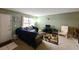 Bright living room with a comfortable sofa, area rug, and a view of the front door and window at 4015 My Lady Ln # 7, Land O Lakes, FL 34638