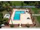 Aerial shot of the community pool, lined with chairs and surrounded by lush landscaping at 4015 My Lady Ln # 7, Land O Lakes, FL 34638