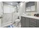 The bathroom features a glass enclosed shower, light gray vanity, and white marble tile at 417 Manor Blvd, Palm Harbor, FL 34683